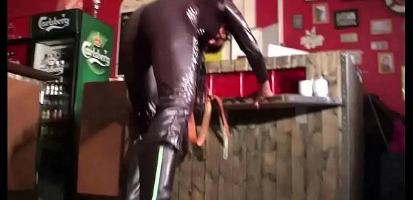  Femdom Amateur Girl in Latex Catsuit and Boots dominate a man in a Bar